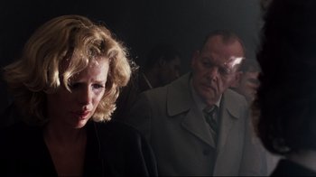 Movie still from “9½ Weeks” (1986), directed by Adrian Lyne – A man and a woman are standing in a room together; Close Up shot, Over the shoulder angle