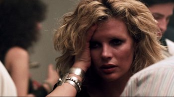 Movie still from “9½ Weeks” (1986), directed by Adrian Lyne – A person holding their hand up to her face; Close Up shot, Over the shoulder angle