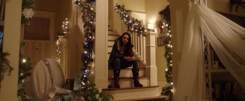 Movie still from “A Bad Moms Christmas” (2017), directed by Scott Moore – A woman sitting on the stairs of a house; Wide shot, Low angle