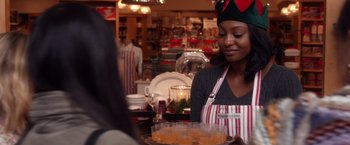 Movie still from “A Bad Moms Christmas” (2017), directed by Scott Moore – A woman in an apron holding a tray of drinks; Medium shot, Over the shoulder angle