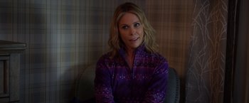 Movie still from “A Bad Moms Christmas” (2017), directed by Scott Moore – A woman sitting in a chair wearing a purple shirt; Close Up shot, Over the shoulder angle