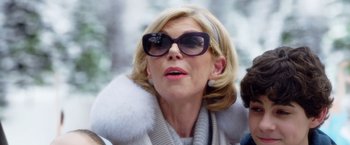 Movie still from “A Bad Moms Christmas” (2017), directed by Scott Moore – A person wearing sunglasses and a coat; Close Up shot, Low angle