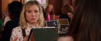Movie still from “A Bad Moms Christmas” (2017), directed by Scott Moore – A woman sitting in front of a group of people; Close Up shot, Over the shoulder angle