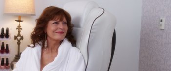 Movie still from “A Bad Moms Christmas” (2017), directed by Scott Moore – A woman sitting in a chair with a towel around her neck; Close Up shot, High angle