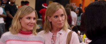 Movie still from “A Bad Moms Christmas” (2017), directed by Scott Moore – Two women standing next to each other in front of a crowd; Close Up shot, Over the shoulder angle