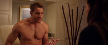 Movie still from “A Bad Moms Christmas” (2017), directed by Scott Moore – A shirtless man in front of a bathroom mirror; Medium shot, Over the shoulder angle