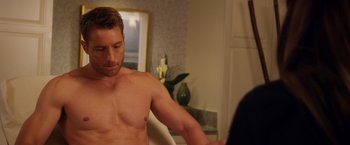 Movie still from “A Bad Moms Christmas” (2017), directed by Scott Moore – A shirtless man is looking at a mirror; Medium shot, Over the shoulder angle