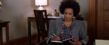 Movie still from “A Bad Moms Christmas” (2017), directed by Scott Moore – A woman sitting in a chair writing in a notebook; Close Up shot, High angle