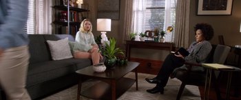 Movie still from “A Bad Moms Christmas” (2017), directed by Scott Moore – A woman sitting on a couch in a living room; Wide shot, Over the shoulder angle