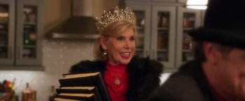 A woman wearing a tiara and a red dress
