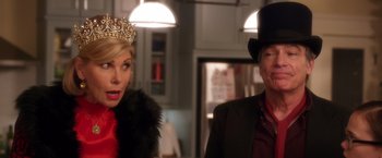 Movie still from “A Bad Moms Christmas” (2017), directed by Scott Moore – A man and a woman wearing a tiara and a top hat; Close Up shot, Over the shoulder angle