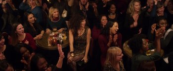 Movie still from “A Bad Moms Christmas” (2017), directed by Scott Moore – A group of people sitting at a table and clapping; Medium shot, High angle