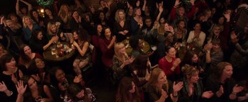 Movie still from “A Bad Moms Christmas” (2017), directed by Scott Moore – A group of people sitting in a room clapping and applauding; Extreme Wide shot, High angle