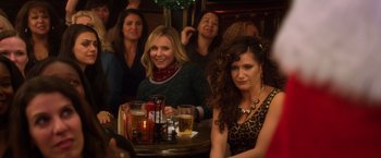 Movie still from “A Bad Moms Christmas” (2017), directed by Scott Moore – A group of women sitting at a table with glasses of beer; Medium shot, Over the shoulder angle