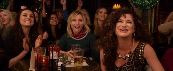 Movie still from “A Bad Moms Christmas” (2017), directed by Scott Moore – A group of people sitting at a table with drinks; Close Up shot, Over the shoulder angle