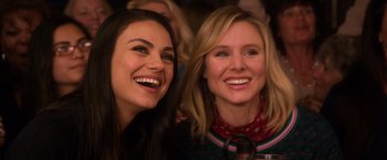 Movie still from “A Bad Moms Christmas” (2017), directed by Scott Moore – Two women smile for the camera at an event; Close Up shot, Over the shoulder angle