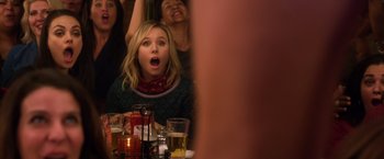 Movie still from “A Bad Moms Christmas” (2017), directed by Scott Moore – A woman is sitting in front of a group of people; Medium shot, Over the shoulder angle