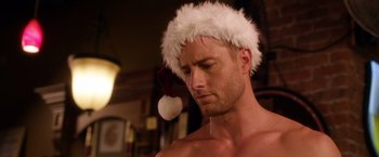 Movie still from “A Bad Moms Christmas” (2017), directed by Scott Moore – A man wearing a santa claus hat and looking down; Close Up shot, Over the shoulder angle