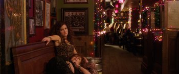 Movie still from “A Bad Moms Christmas” (2017), directed by Scott Moore – Two women sitting on a bench in a bar; Medium shot, High angle