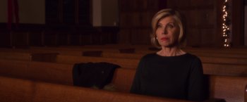 Movie still from “A Bad Moms Christmas” (2017), directed by Scott Moore – A woman sitting in a pew with a dog in the background; Close Up shot, Low angle