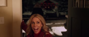 Movie still from “A Bad Moms Christmas” (2017), directed by Scott Moore – A blonde woman in a red shirt is smiling for the camera; Close Up shot, Over the shoulder angle