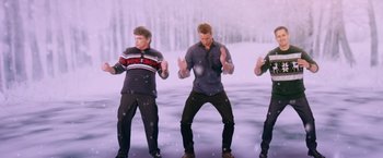 Movie still from “A Bad Moms Christmas” (2017), directed by Scott Moore – A group of people standing in the middle of a snow covered field; Medium shot, Over the shoulder angle