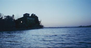 Movie still from “A Bay of Blood” (1971), directed by Mario Bava – A house on a small island in the middle of the ocean; Extreme Wide shot, Low angle