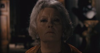 Movie still from “A Bay of Blood” (1971), directed by Mario Bava – An older woman with gray hair looking at the camera; Close Up shot, Low angle