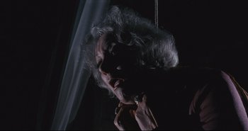 Movie still from “A Bay of Blood” (1971), directed by Mario Bava – A woman with long white hair hanging from a rope; Close Up shot, Low angle