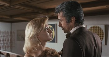 Movie still from “A Bay of Blood” (1971), directed by Mario Bava – A man and a woman looking at one another; Medium shot, Low angle
