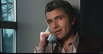 Movie still from “A Bay of Blood” (1971), directed by Mario Bava – A person talking on a phone; Close Up shot, High angle