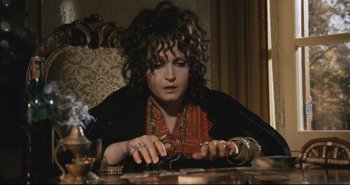 Movie still from “A Bay of Blood” (1971), directed by Mario Bava – A woman sitting at a table with a bunch of cards; Medium shot, High angle