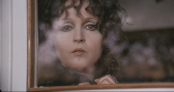 Movie still from “A Bay of Blood” (1971), directed by Mario Bava – A person looking through a window; Close Up shot, Over the shoulder angle
