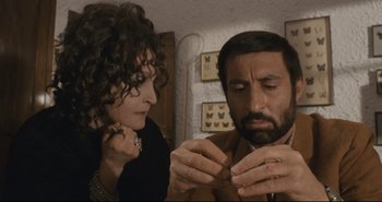 Movie still from “A Bay of Blood” (1971), directed by Mario Bava – A man and a woman looking at each other's nails; Close Up shot, High angle