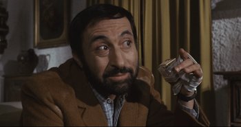 Movie still from “A Bay of Blood” (1971), directed by Mario Bava – A person holding a glass of water; Close Up shot, High angle