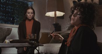 Movie still from “A Bay of Blood” (1971), directed by Mario Bava – Two women sitting in a living room with a glass of wine and a cigarette; Medium shot, Low angle