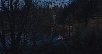 Movie still from “A Bay of Blood” (1971), directed by Mario Bava – Two people in a boat on a lake at night; Extreme Wide shot, High angle