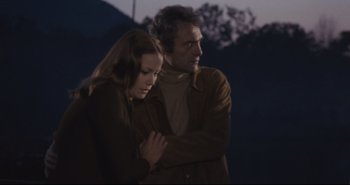 Movie still from “A Bay of Blood” (1971), directed by Mario Bava – A man and a woman standing next to each other; Medium shot, Low angle