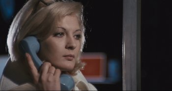 Movie still from “A Bay of Blood” (1971), directed by Mario Bava – A woman holding a phone up to her ear; Close Up shot, Low angle