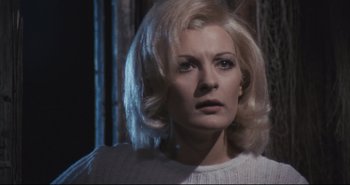 Movie still from “A Bay of Blood” (1971), directed by Mario Bava – A woman with blonde hair wearing a white sweater; Close Up shot, Low angle