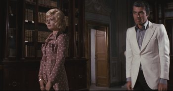 Movie still from “A Bay of Blood” (1971), directed by Mario Bava – A man and a woman standing next to each other in a room; Medium shot, Low angle