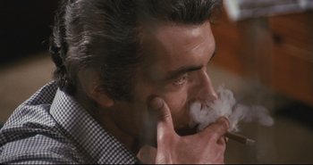 Movie still from “A Bay of Blood” (1971), directed by Mario Bava – A person smoking a cigarette; Close Up shot, High angle