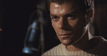 Movie still from “A Bay of Blood” (1971), directed by Mario Bava – A person wearing a sweater; Close Up shot, Low angle