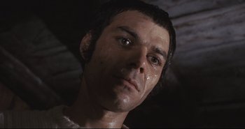 Movie still from “A Bay of Blood” (1971), directed by Mario Bava – A man's face in a dark room; Close Up shot, Low angle