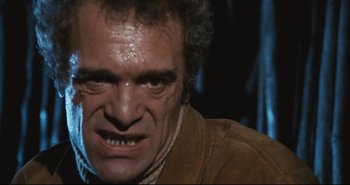 Movie still from “A Bay of Blood” (1971), directed by Mario Bava – An old man with a frowning look on his face; Close Up shot, Low angle