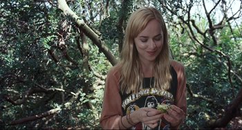 Movie still from “A Bigger Splash” (2015), directed by Luca Guadagnino – A woman holding a bird in her hands; Close Up shot, Over the shoulder angle