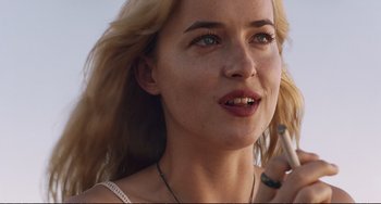 Movie still from “A Bigger Splash” (2015), directed by Luca Guadagnino – A person using a cell phone; Close Up shot, Low angle