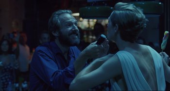 Movie still from “A Bigger Splash” (2015), directed by Luca Guadagnino – A man and a woman in a room with lights on; Close Up shot, Over the shoulder angle