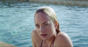 Movie still from “A Bigger Splash” (2015), directed by Luca Guadagnino – A beautiful young lady sitting in the water; Close Up shot, High angle