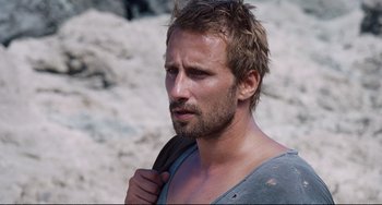 Movie still from “A Bigger Splash” (2015), directed by Luca Guadagnino – A person with a beard; Close Up shot, Over the shoulder angle